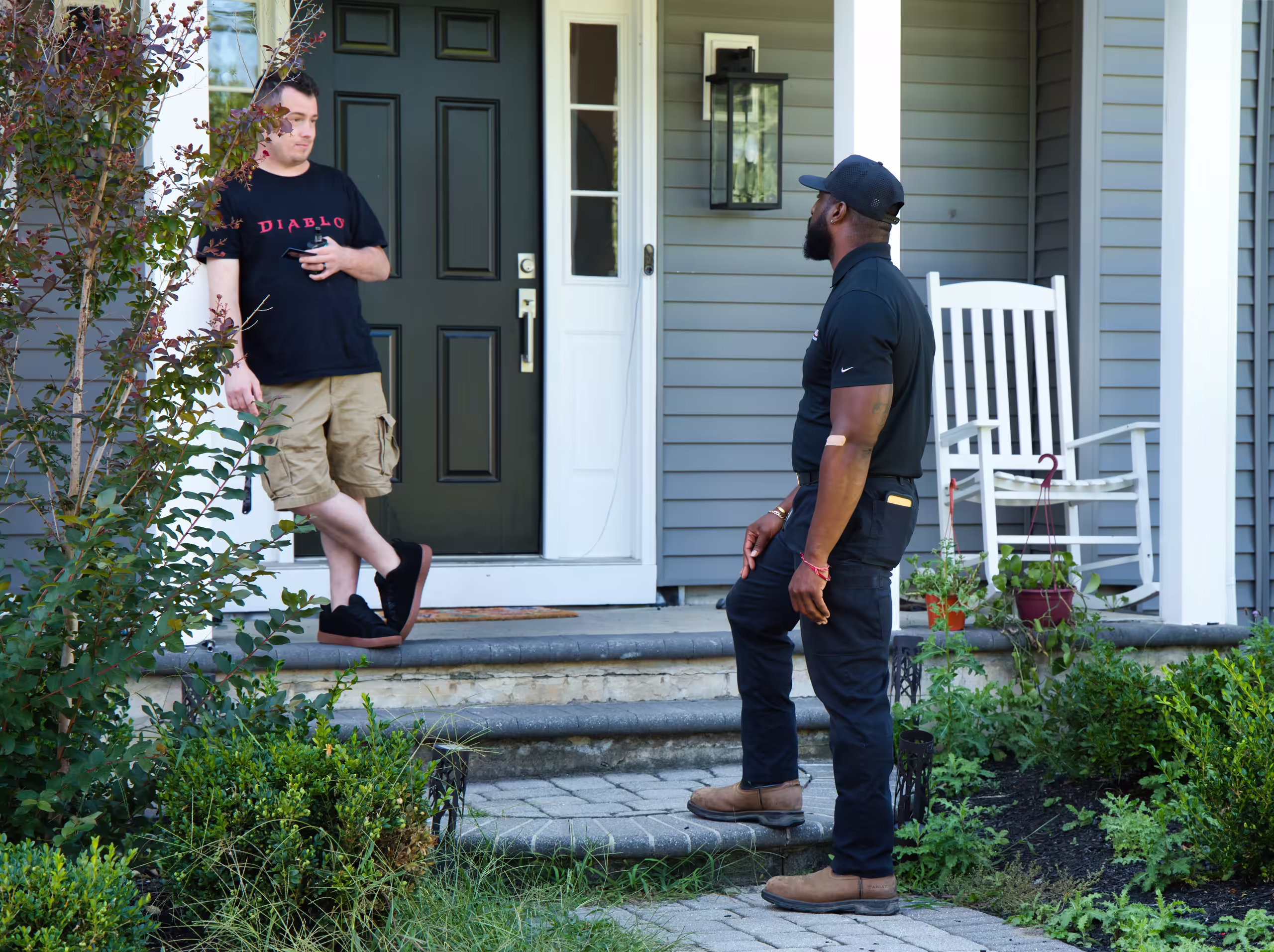Drain technician meeting homeowner at front door