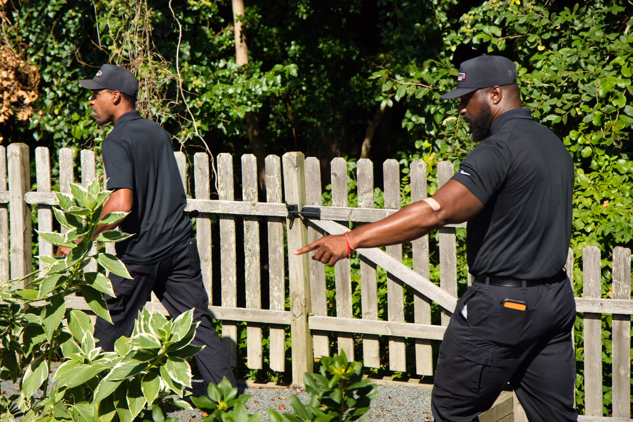 Drain technicians entering backyard for sewer access