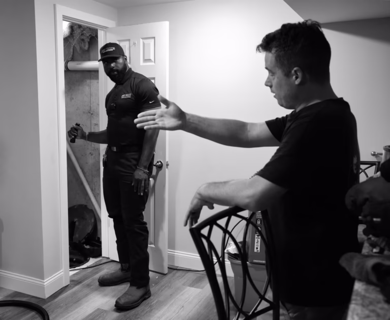 Homeowner showing drain problem to technician