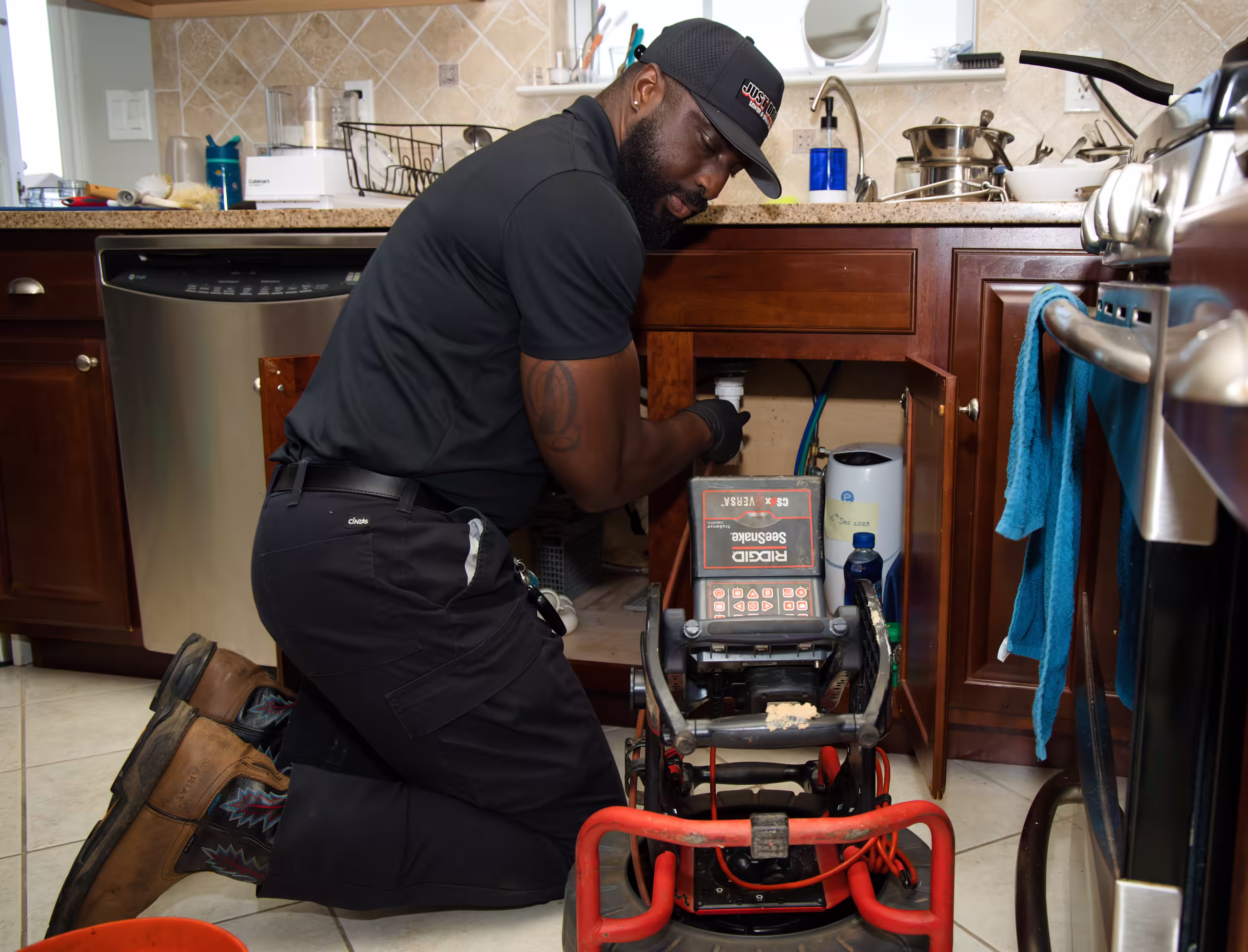 Plumber operating RIDGID drain cleaning machine